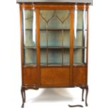 An Edwardian mahogany central display cabinet, of serpentine form,