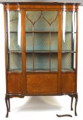 An Edwardian mahogany central display cabinet, of serpentine form,