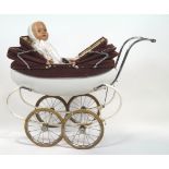 A vintage Triang doll's pram and a doll,