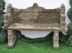A reconstituted stone bench the back panel decorated with opposing griffins,