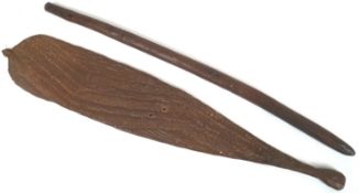 A tribal carved wood fighting stick with incised linear decoration