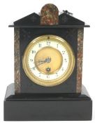 A black slate clock with double pediment top and marble accents over a round cream Arabic dial,