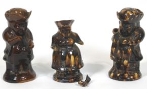 Two Staffordshire pottery treacle glazed Toby jugs and a teapot and cover, 19th century,