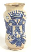 A Continental pottery Albarello jar, cobalt decorated with an armorial achievement with a tower,