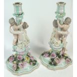 A pair of 19th century Sitzendorf porcelain candlesticks, of rococo design,