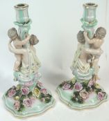 A pair of 19th century Sitzendorf porcelain candlesticks, of rococo design,