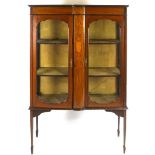 An Edwardian mahogany display cabinet with two glazed doors flanking a marquetry panel