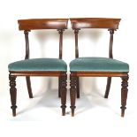 Two William IV mahogany dining chairs, with shaped bar backs and foliate carved uprights,