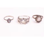 A collection of eight silver dress rings of variable designs.