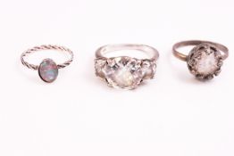 A collection of eight silver dress rings of variable designs.