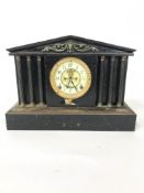 An early 20th century cast iron and brass mounted mantel clock,the case of architectural form,