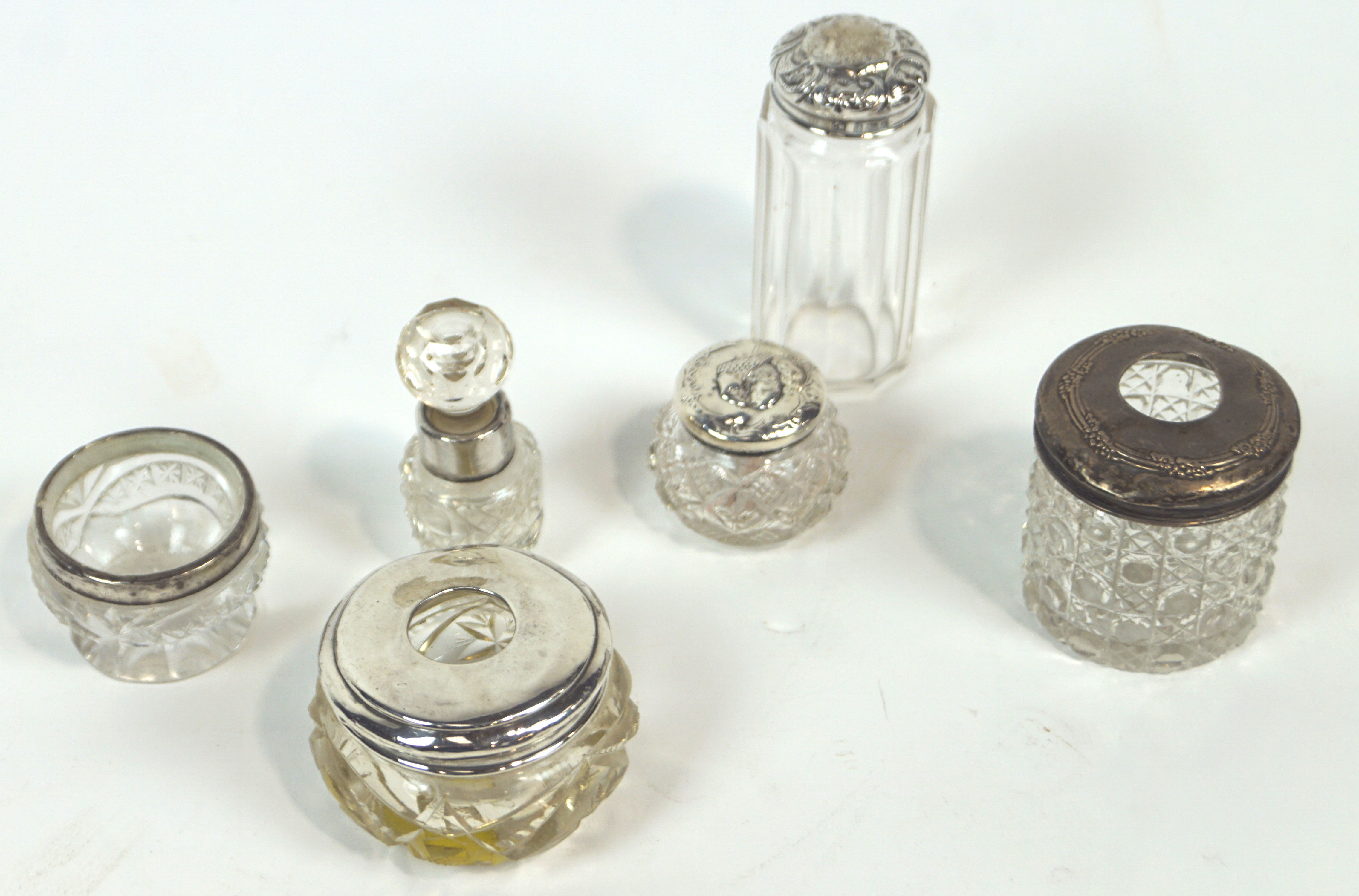 A group of six silver and white metal mounted cut glass items, to include a salt and a hair tidy,