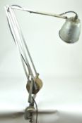 A mixed metal angle poise lamp with counter balance weight and a clamp base by Hardrill & Horstman,
