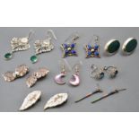A collection of eight pairs of silver earrings of variable designs.