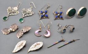 A collection of eight pairs of silver earrings of variable designs.