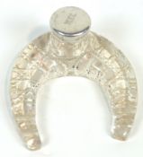 A cut glass and silver ink stand, the glass base shaped like a life size horseshoe,