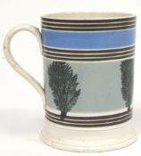 A Staffordshire pottery mocha ware cylindrical mug, mid 19th century,
