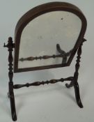 A mahogany framed arch topped swing mirror, of small proportions,