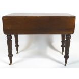A 19th century mahogany Pembroke table, on turned baluster legs with brass caps and casters,