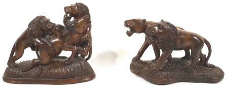 An African teak wood carving of a lion pair, 27cm high,