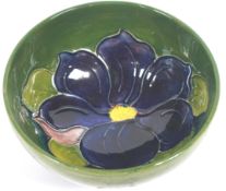 A Moorcroft 'Clematis' pattern small green ground bowl, impressed marks,