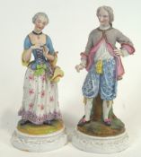 A pair of 19th century polychrome decorated Continental bisque porcelain figures