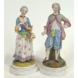 A pair of 19th century polychrome decorated Continental bisque porcelain figures