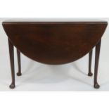 A George III mahogany drop leaf dining table, of oval form having two leaves, on pad feet,