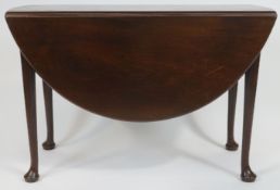 A George III mahogany drop leaf dining table, of oval form having two leaves, on pad feet,