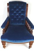 A 19th century Victorian mahogany library reading chair, with buttoned back rest, turned arm rest,