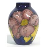 A Moorcroft 'Clematis' pattern blue ground small oriform vase, impressed marks,
