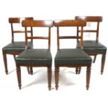 A set of four Victorian mahogany dining chairs with rail backs and leatherette stuff over seats,
