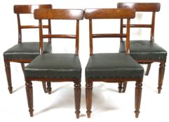 A set of four Victorian mahogany dining chairs with rail backs and leatherette stuff over seats,