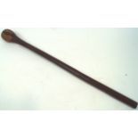 A war club, in hardwood, of plain mace form, the baluster end chip carved with sinuous decoration,