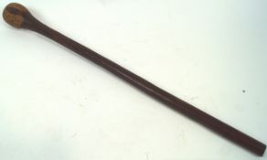A war club, in hardwood, of plain mace form, the baluster end chip carved with sinuous decoration,