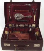 A Morocco red leather ladies travelling dressing case, lined with moire silk,