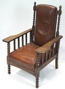 An early 20th century Art & Crafts oak lounge chair, having stuffed and brown leather upholstery,