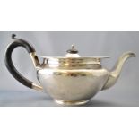 A round silver teapot, of very plain form,