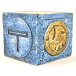 A Troika pottery blue glazed cube vase, of square form with round panel decorations to the sides,