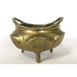 A Chinese gilt bronze small two handled censor, of lobed circular form, on three feet,
