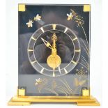 A Jeager Le Coultre clock, of rectangular black perspex and gilt form,
