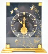 A Jeager Le Coultre clock, of rectangular black perspex and gilt form,