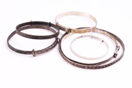 A collection of six expanding bangles, all marked or hallmarked for silver.