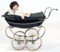 A vintage Silver Cross dolls pram and doll, with navy coloured hood and undercarriage,