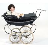 A vintage Silver Cross dolls pram and doll, with navy coloured hood and undercarriage,