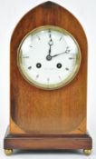 An Edwardian mahogany and boxwood strung lancet shaped mantel clock on gilt paw feet,