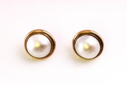 A large pair of yellow metal stud earrings each set with a 14.0mm mabe pearl.