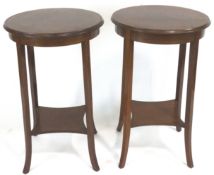 A pair of Edwardian occasional tables, of rounded form,