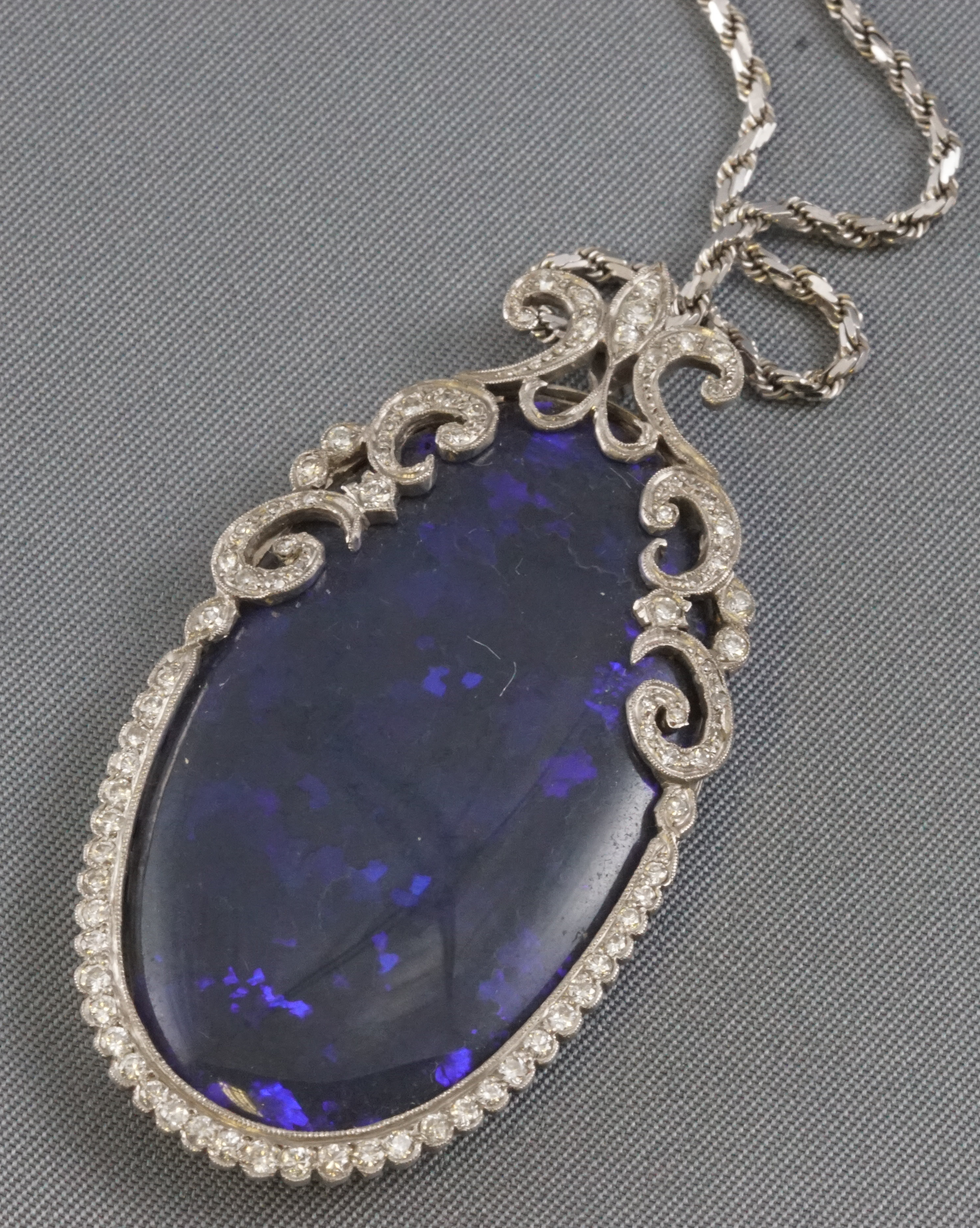 A white metal Edwardian style pendant principally set with an oval cabochon cut black opal - Image 2 of 2