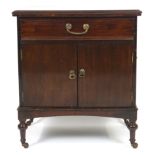 An early 20th century mahogany bedside cabinet with a drawer over two plain doors,